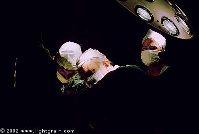 surgeons and nurse in operating theatre