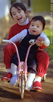 children on tricycle
